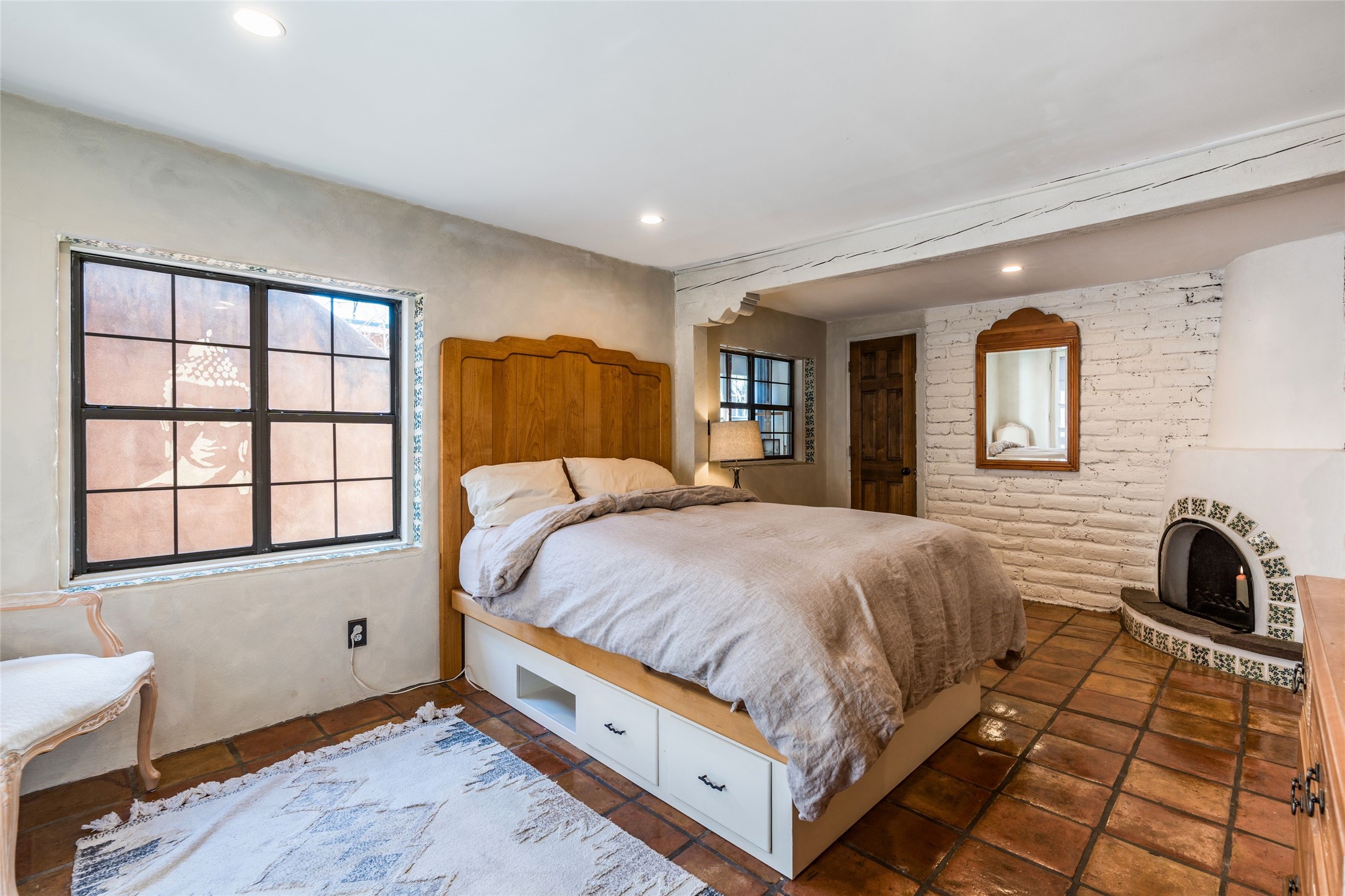 1402 Bishops Lodge Road, Unit A Santa Fe, NM 87506 - Photo 22 of 40 - Primary Bedroom w/ Kiva Fireplace