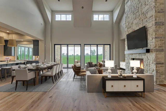 a kitchen with stainless steel appliances kitchen island granite countertop a table chairs in it and wooden floors