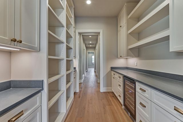 a bedroom with a bed and large windows