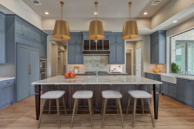 a kitchen with cabinets and chairs
