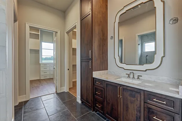 a bathroom with a double vanity sink mirror and shower
