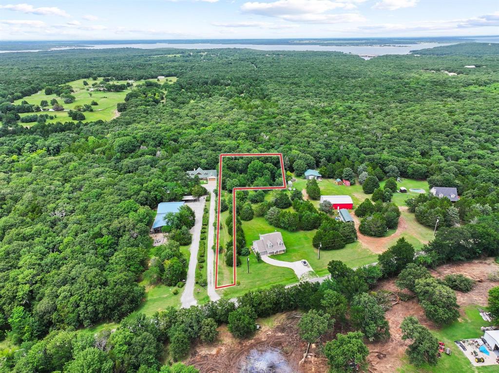 207 Paradise Park Road Pottsboro, TX 75076 - Photo 5 of 28 Expansive aerial perspective showcasing a wooded property delineated by a red boundary