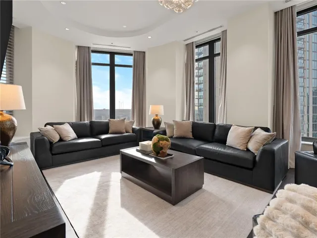 a kitchen with stainless steel appliances kitchen island granite countertop a dining table and chairs