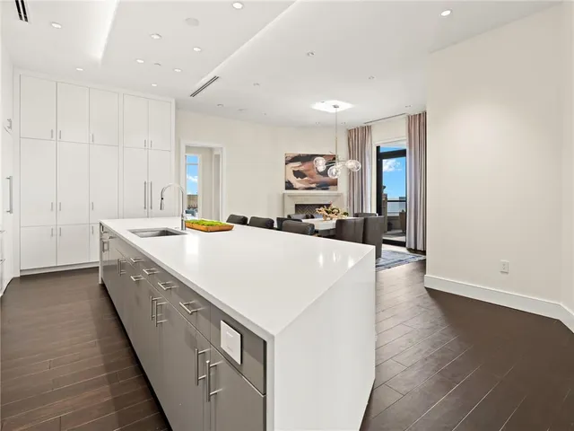 a view of a dining room with furniture and a chandelier