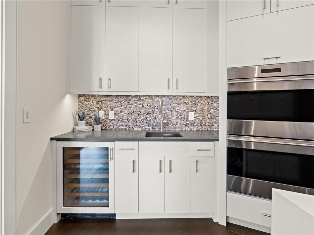 3376 Peachtree Road Northeast, Unit 35B Atlanta, GA 30326 - Photo 23 of 80 a kitchen with granite countertop white cabinets and white appliances