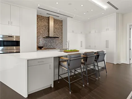 a kitchen with granite countertop white cabinets and a sink