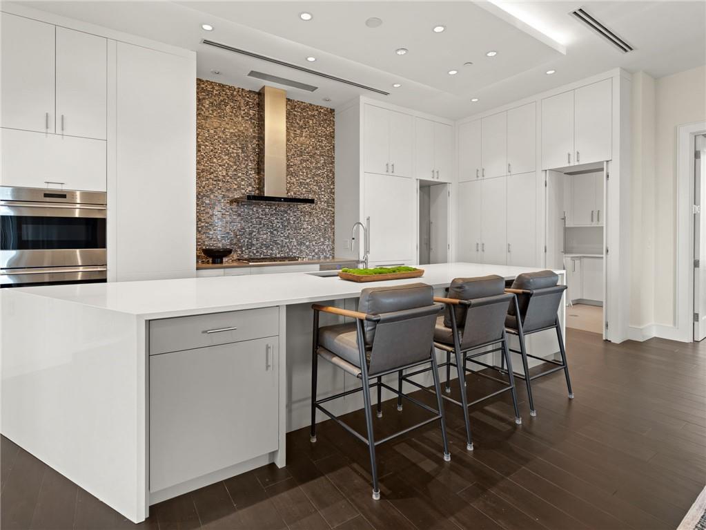 3376 Peachtree Road Northeast, Unit 35B Atlanta, GA 30326 - Photo 27 of 80 a kitchen with a table chairs and a refrigerator