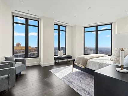 a bedroom with a flat screen tv and a bathtub