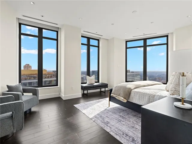 a bedroom with a flat screen tv and a bathtub