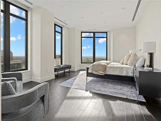 a bedroom with a large bed and a large window