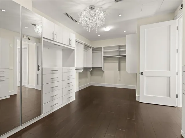 a room with lots of chairs and mirrors