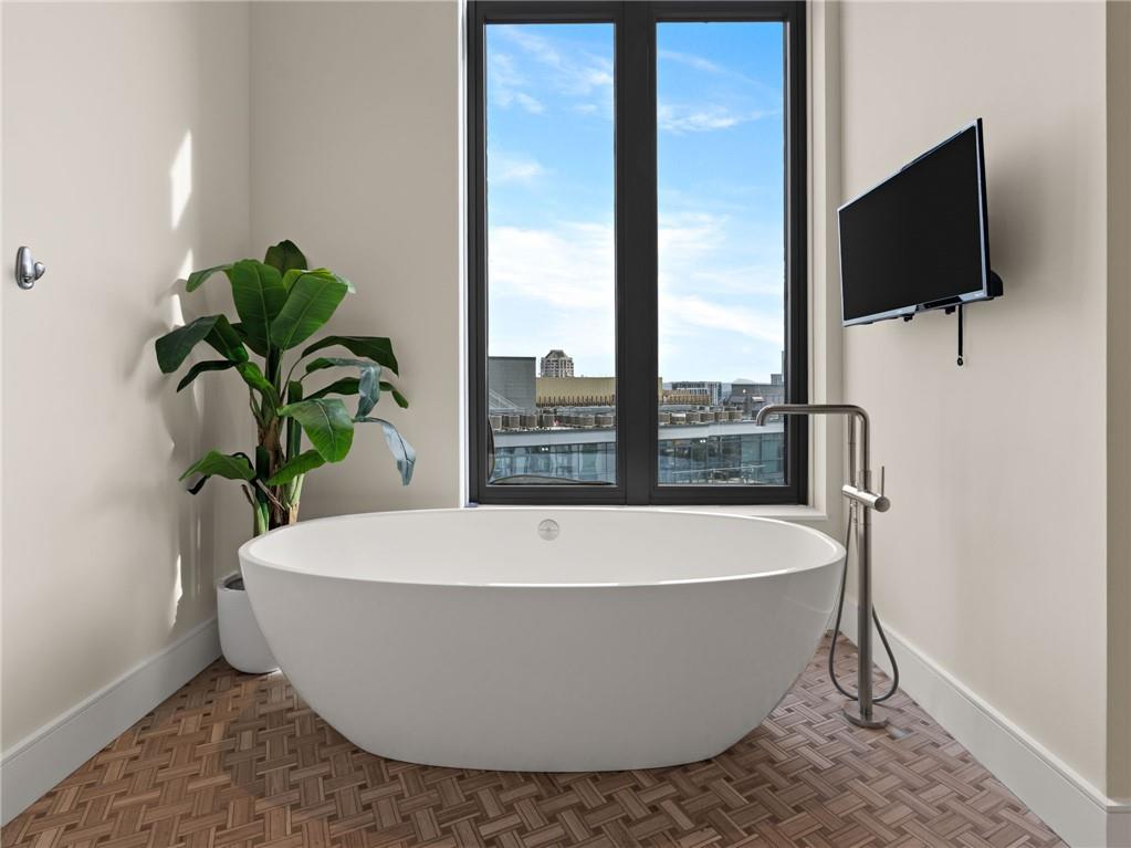 3376 Peachtree Road Northeast, Unit 35B Atlanta, GA 30326 - Photo 53 of 80 a white bath tub sitting in a bathroom