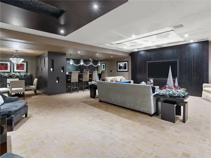 a living room with furniture windows and a chandelier