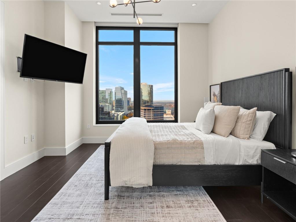 3376 Peachtree Road Northeast, Unit 35B Atlanta, GA 30326 - Photo 61 of 80 a bedroom with a bed and a flat tv screen on the dresser