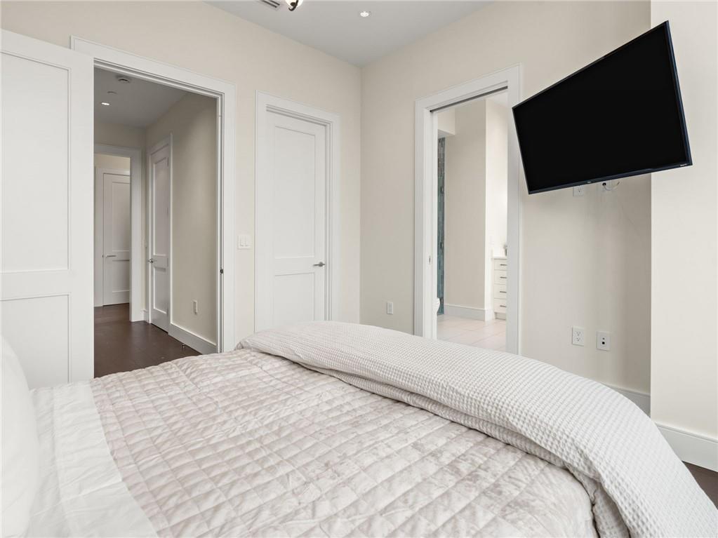 3376 Peachtree Road Northeast, Unit 35B Atlanta, GA 30326 - Photo 63 of 80 a bedroom with a flat screen tv and a bathtub