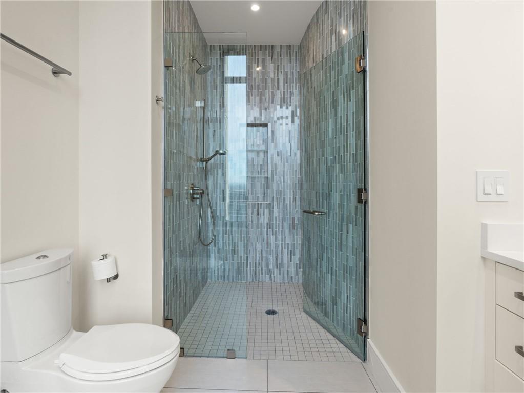 3376 Peachtree Road Northeast, Unit 35B Atlanta, GA 30326 - Photo 65 of 80 a bathroom with a shower and a toilet