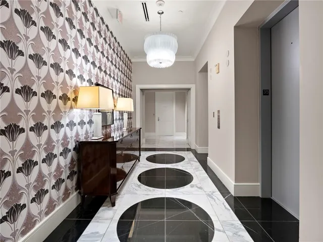 a living room with furniture a chandelier and a flat screen tv