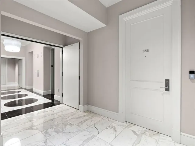 a living room with furniture potted plant and a chandelier