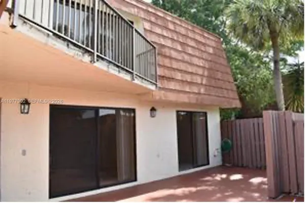 a view of a wooden door with a house