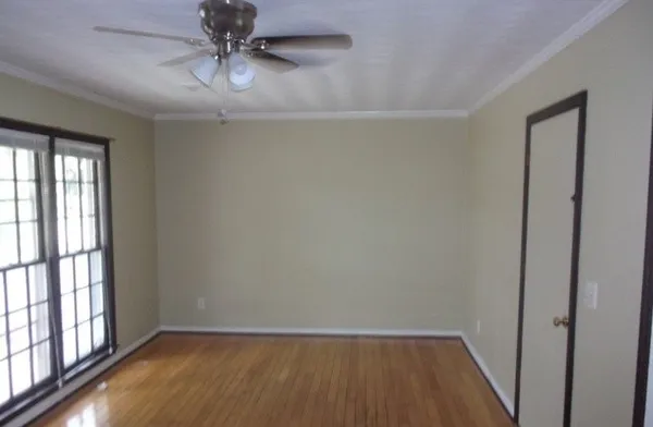 wooden floor in an empty room with a window
