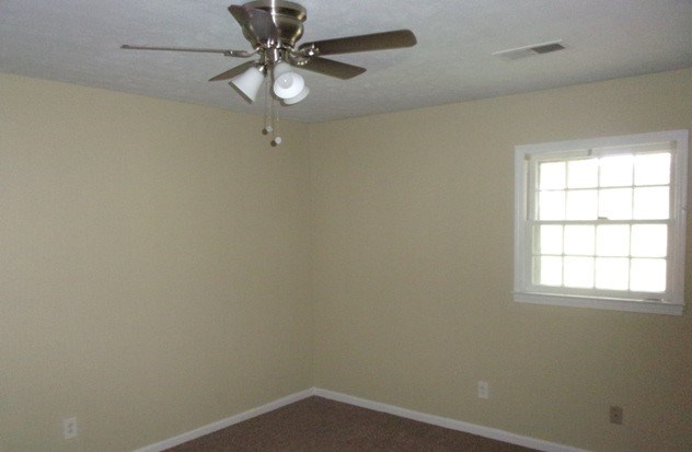6312 Moon Road Columbus, GA 31909 - Photo 7 of 12 an empty room with a window and a fan