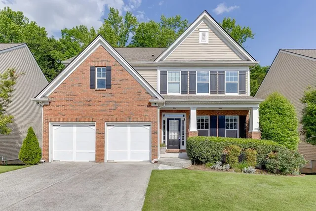 a front view of a house with a yard and garage