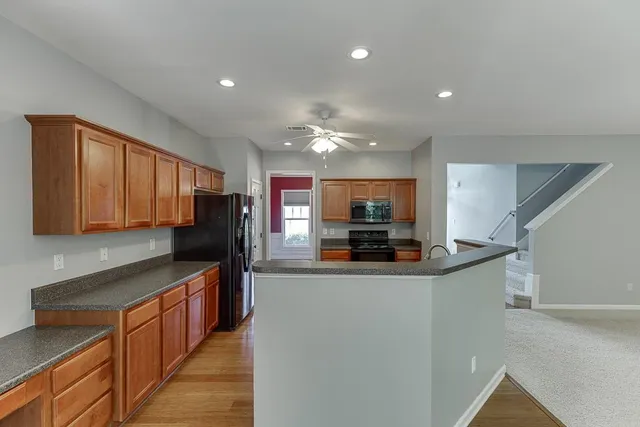 a kitchen with stainless steel appliances granite countertop a sink and stove