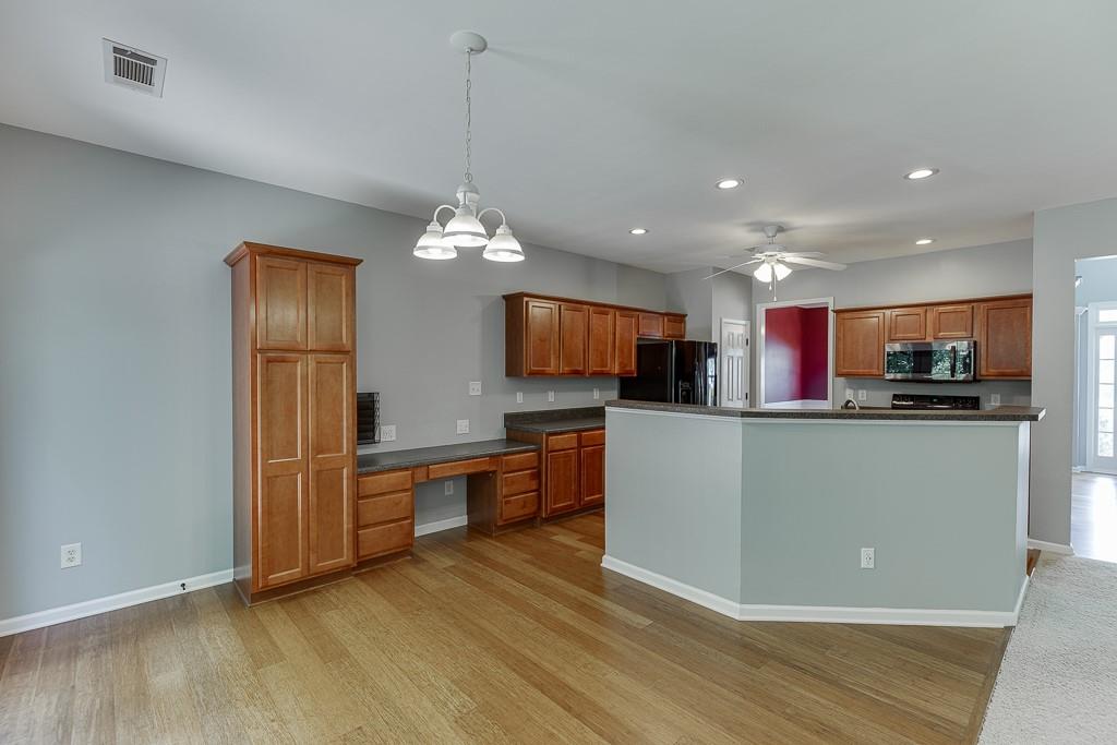 2365 Valley Mill Drive Buford, GA 30519 - Photo 14 of 53 a kitchen with stainless steel appliances granite countertop a refrigerator a oven a sink and dishwasher with wooden floor