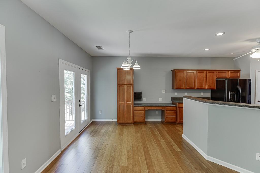 2365 Valley Mill Drive Buford, GA 30519 - Photo 16 of 53 a kitchen with stainless steel appliances granite countertop a refrigerator a sink dishwasher a stove and white countertops with wooden floor