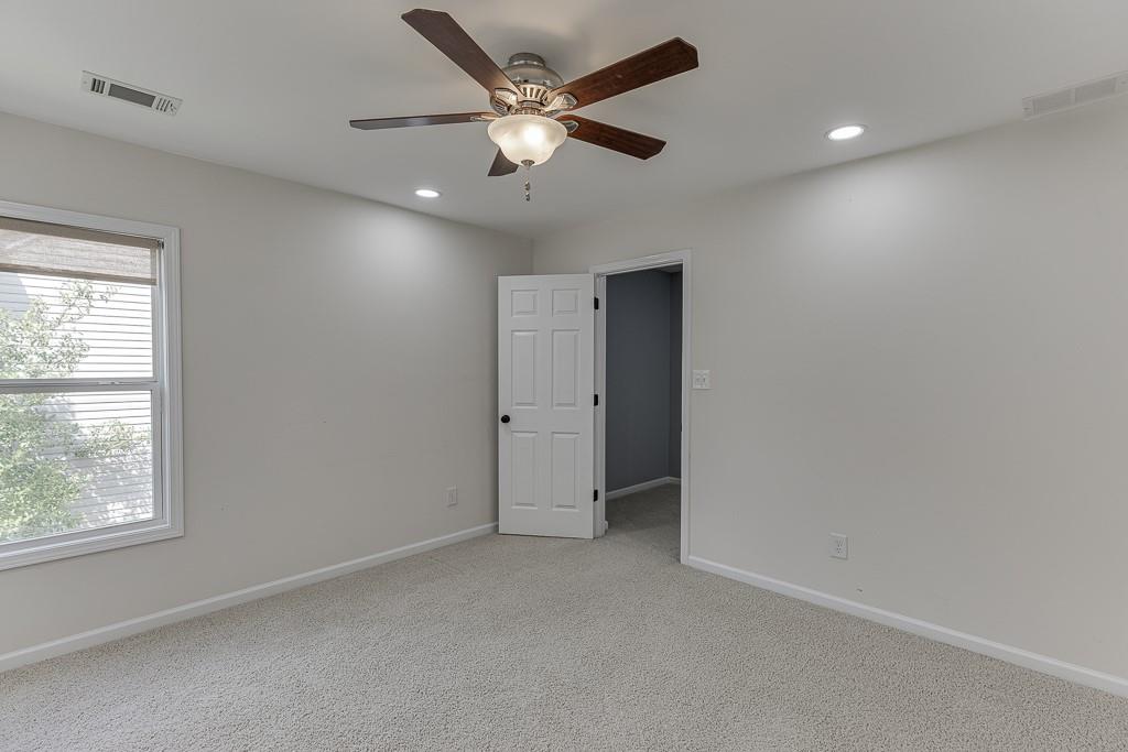 2365 Valley Mill Drive Buford, GA 30519 - Photo 24 of 53 an empty room with a ceiling fan and a window