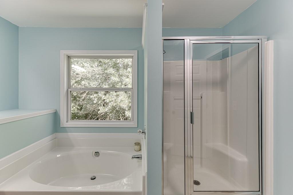 2365 Valley Mill Drive Buford, GA 30519 - Photo 30 of 53 a bathroom with a bathtub and a shower