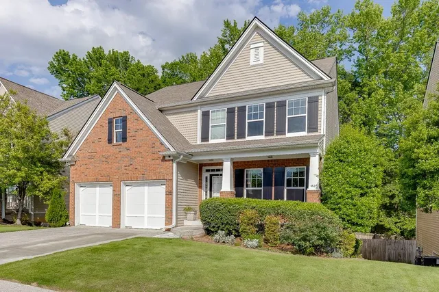 a front view of a house with a yard