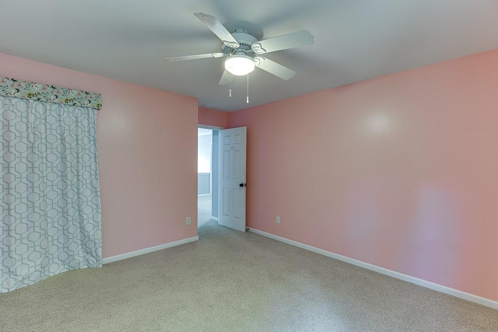 2365 Valley Mill Drive Buford, GA 30519 - Photo 32 of 53 an empty room with a chandelier fan and windows
