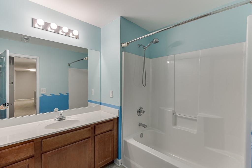 2365 Valley Mill Drive Buford, GA 30519 - Photo 33 of 53 a bathroom with a bath tub sink mirror and shower