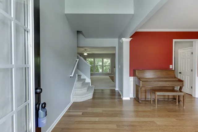 a view of entryway and hall with wooden floor