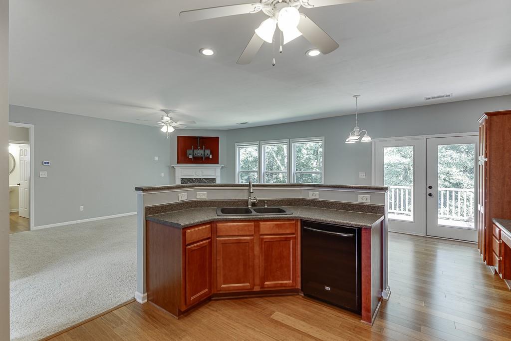 2365 Valley Mill Drive Buford, GA 30519 - Photo 8 of 53 a kitchen with granite countertop a stove and a wooden floors