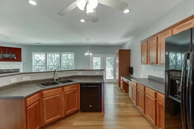 a kitchen with stainless steel appliances granite countertop a sink and cabinets