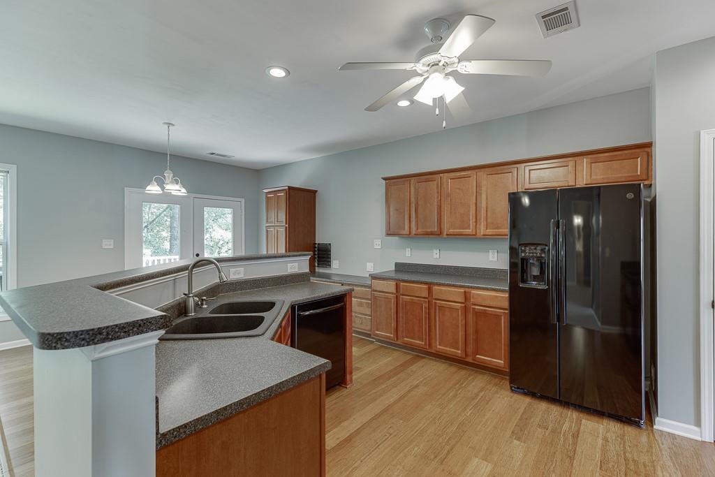 2365 Valley Mill Drive Buford, GA 30519 - Photo 10 of 53 a kitchen with granite countertop a stove cabinets and refrigerator