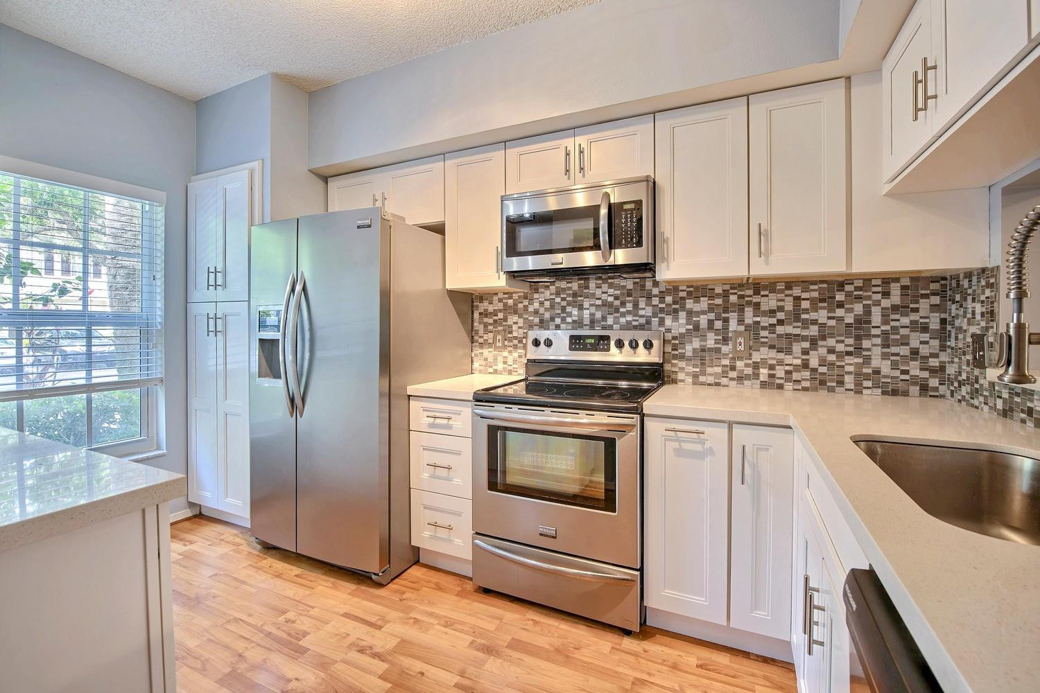 154 Southwest 96th Terrace Plantation, FL 33324 - Photo 5 of 10 a kitchen with granite countertop a sink stove and refrigerator