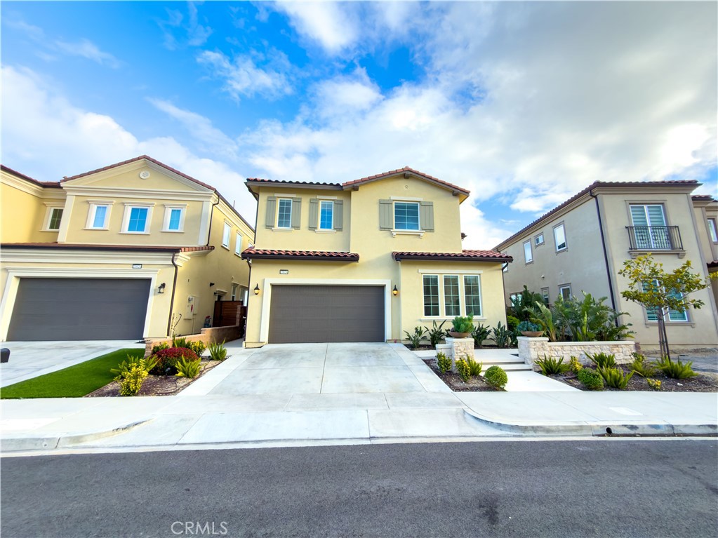 20626 Deer Grass Court Porter Ranch, CA 91326 - Photo 2 of 45 a front view of a house with a yard and garage