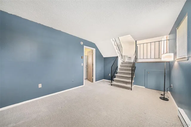 a view of an empty room with stairs