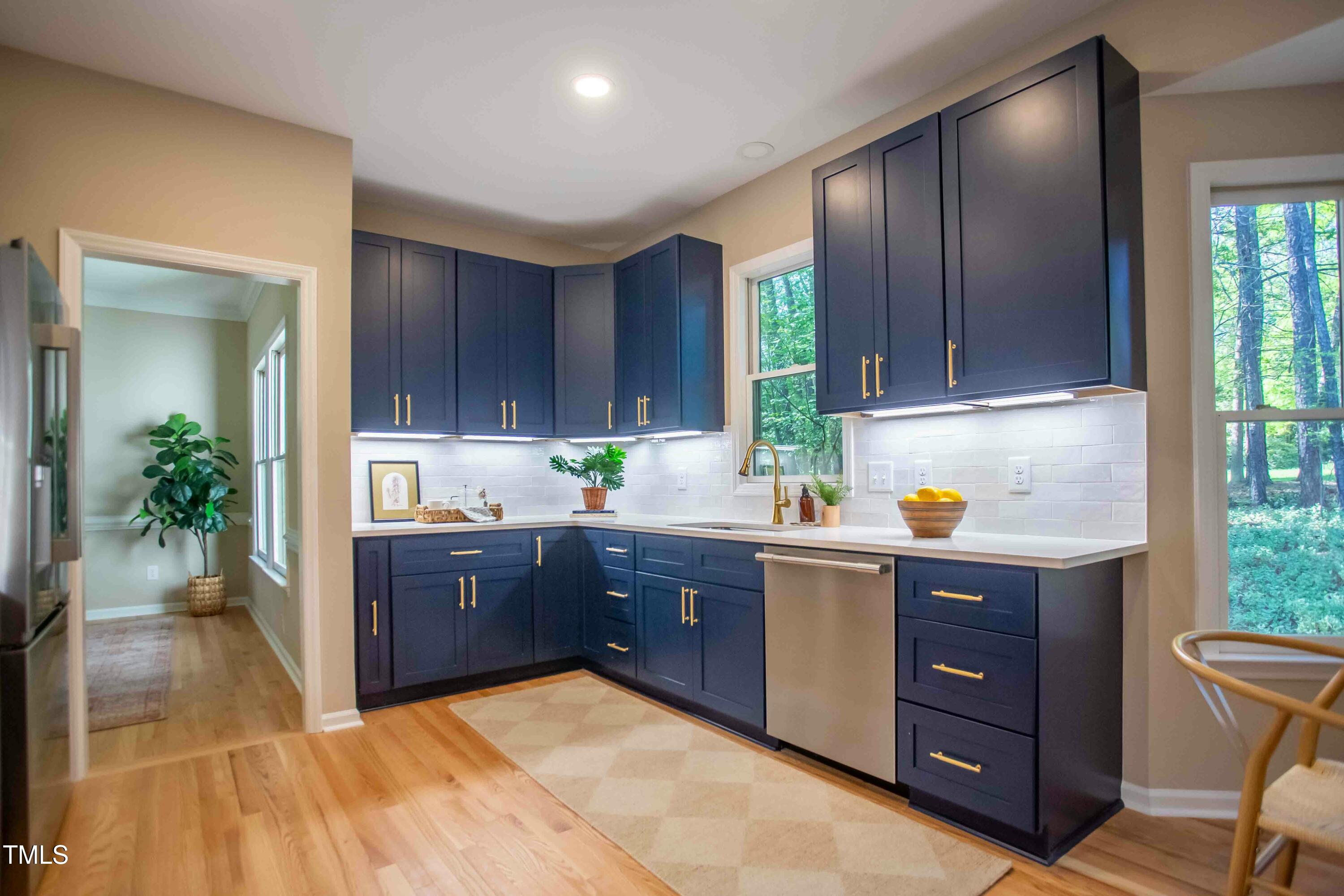 103 Windhover Drive Chapel Hill, NC 27514 - Photo 20 of 61 a kitchen with stainless steel appliances granite countertop wooden cabinets a stove a sink and a window
