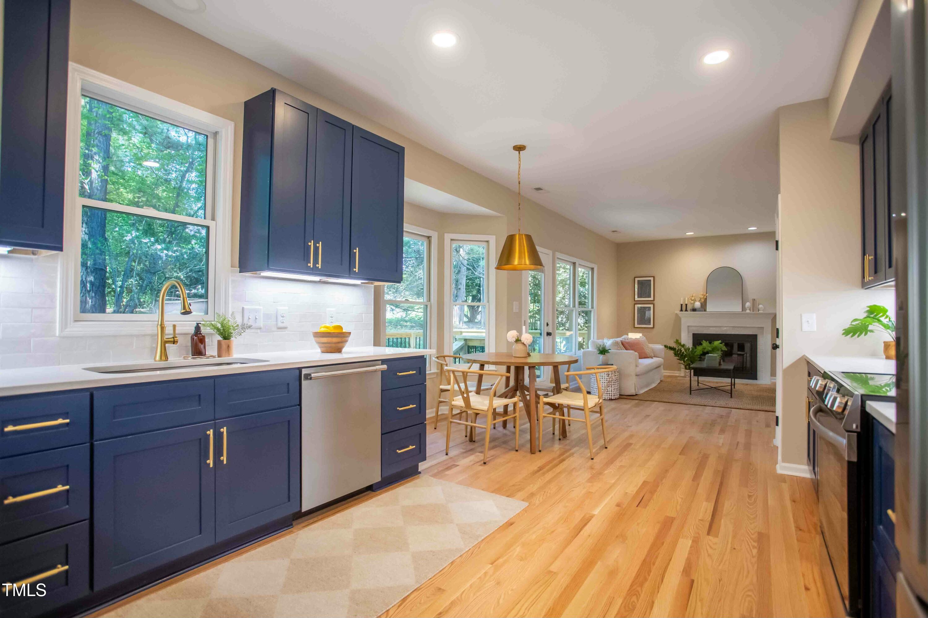 103 Windhover Drive Chapel Hill, NC 27514 - Photo 22 of 61 a kitchen with sink cabinets and wooden floor