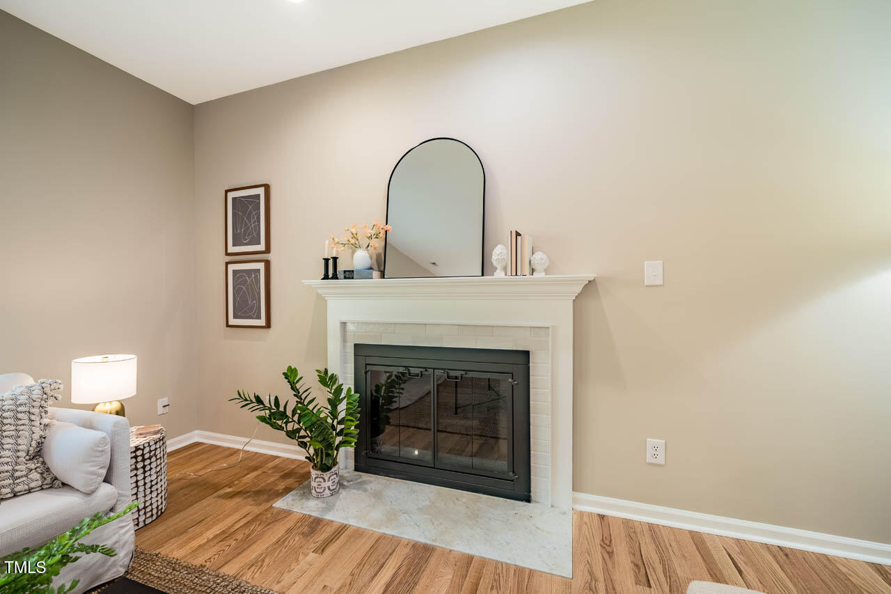 103 Windhover Drive Chapel Hill, NC 27514 - Photo 25 of 61 a view of a livingroom with a fireplace and wooden floor