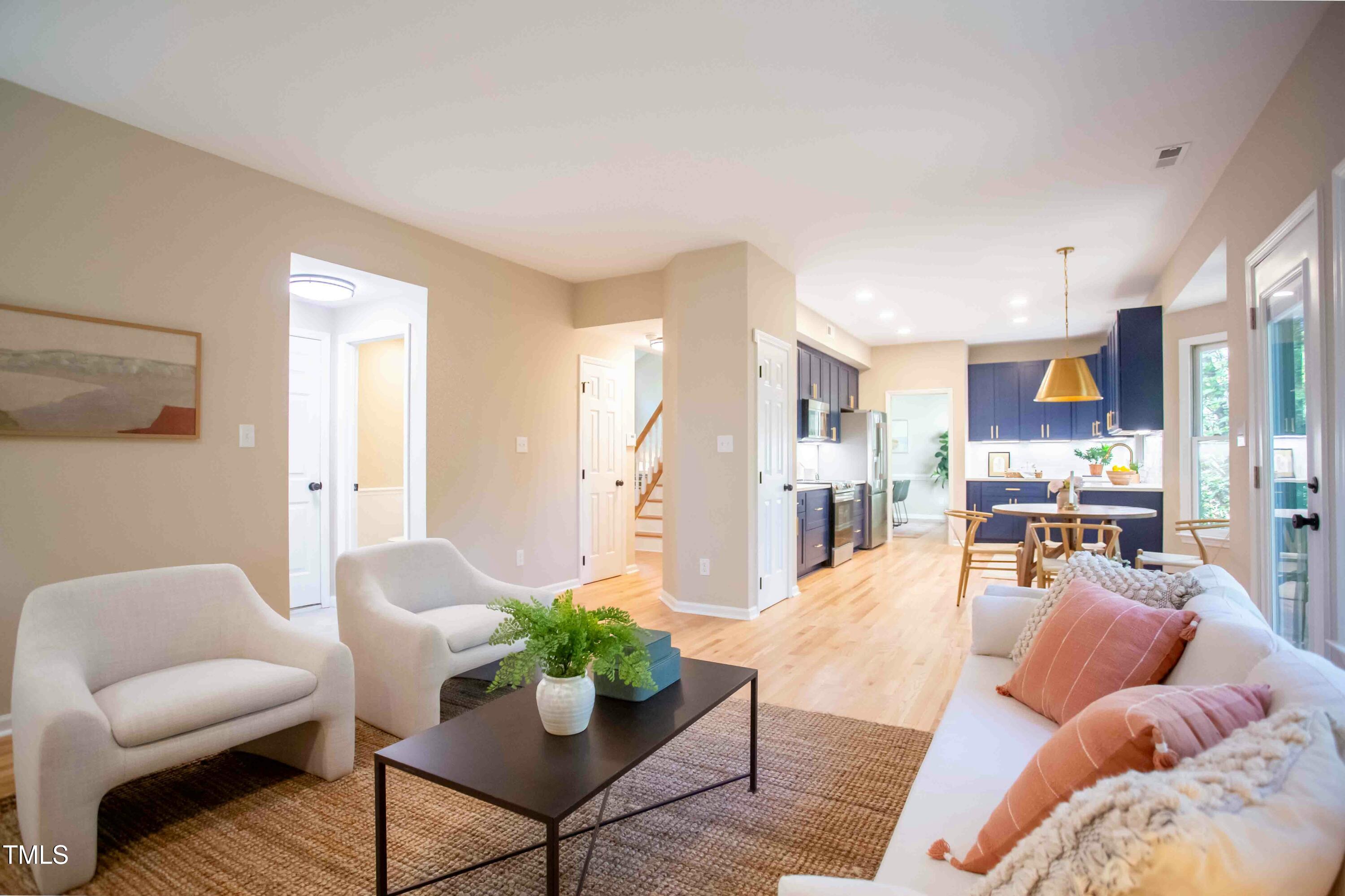 103 Windhover Drive Chapel Hill, NC 27514 - Photo 27 of 61 a living room with furniture kitchen view and a potted plant