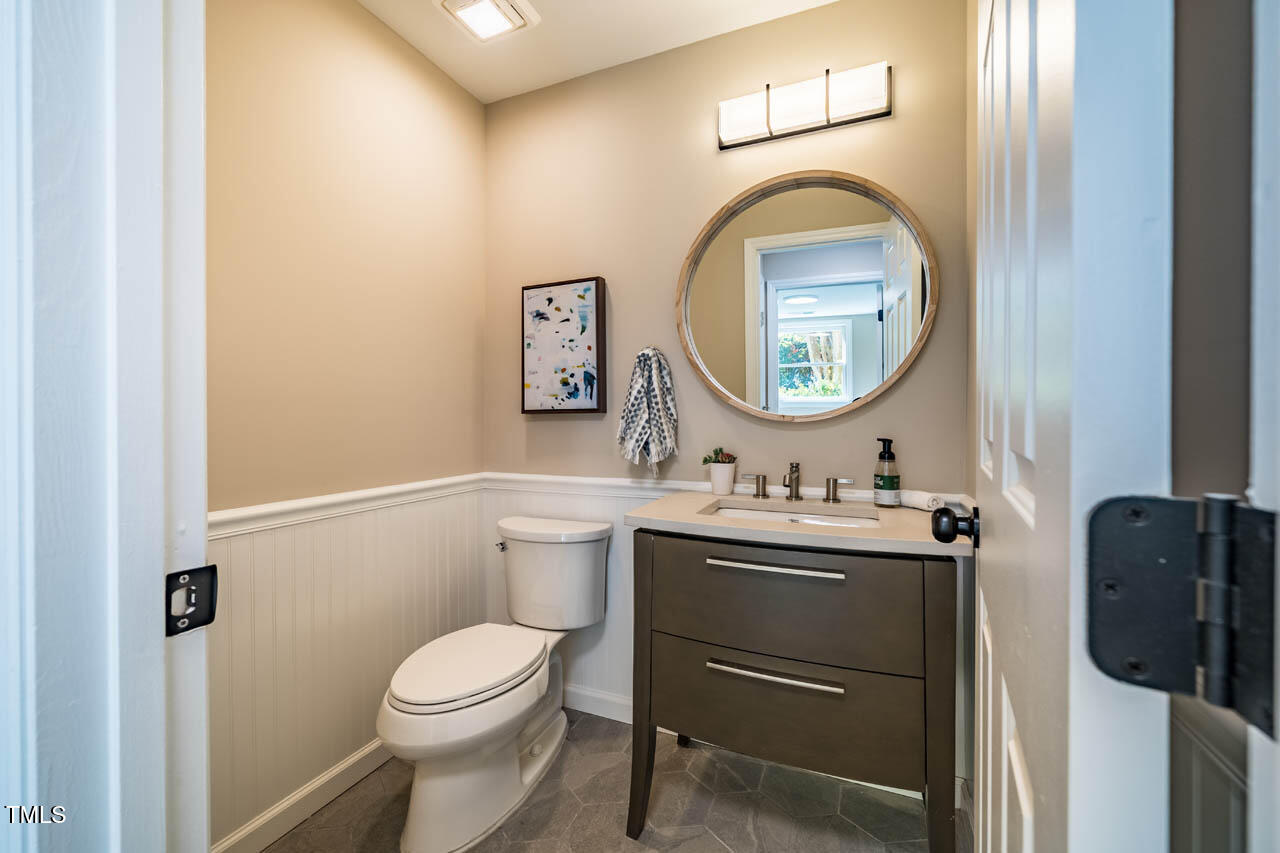 103 Windhover Drive Chapel Hill, NC 27514 - Photo 29 of 61 a bathroom with a toilet a sink and mirror