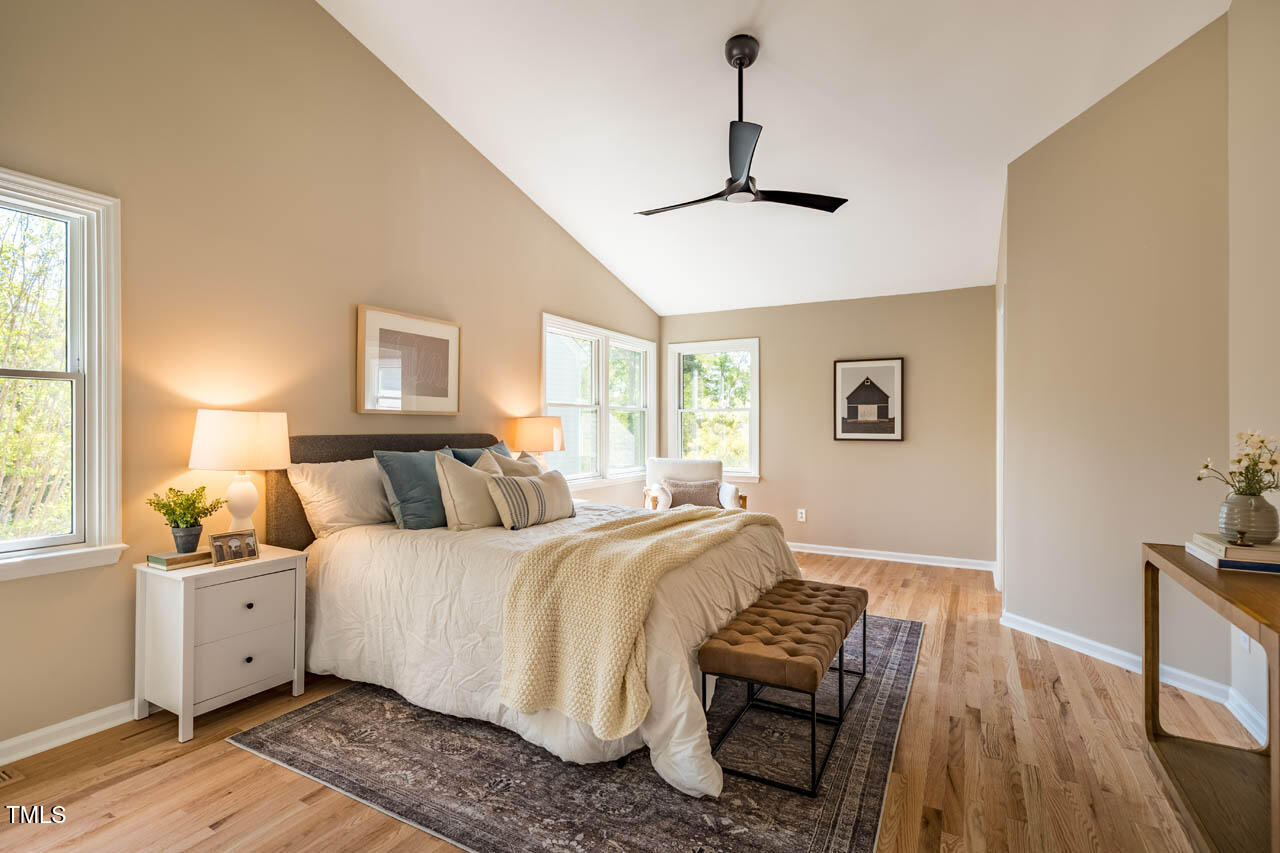 103 Windhover Drive Chapel Hill, NC 27514 - Photo 33 of 61 a bedroom with a bed and wooden floor