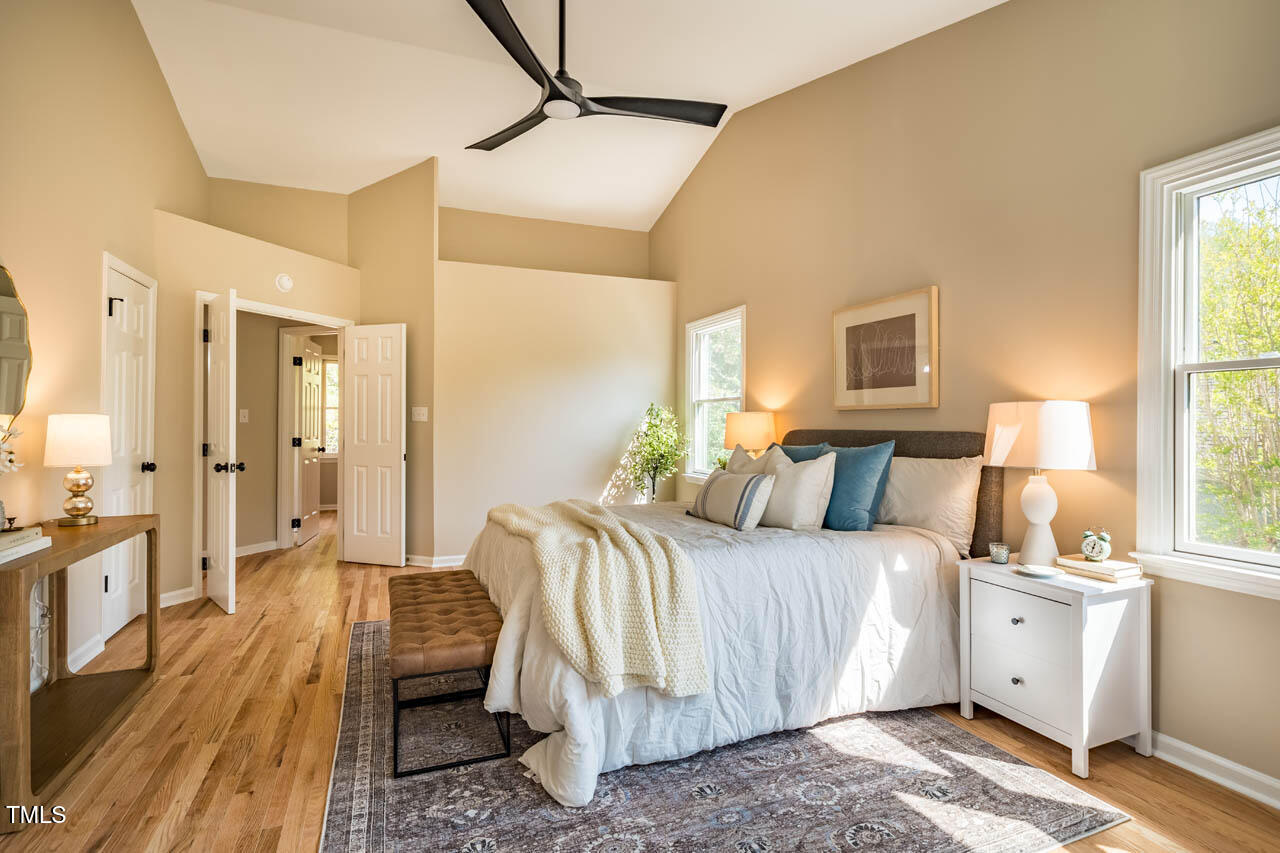 103 Windhover Drive Chapel Hill, NC 27514 - Photo 34 of 61 a bedroom with a bed and wooden floor