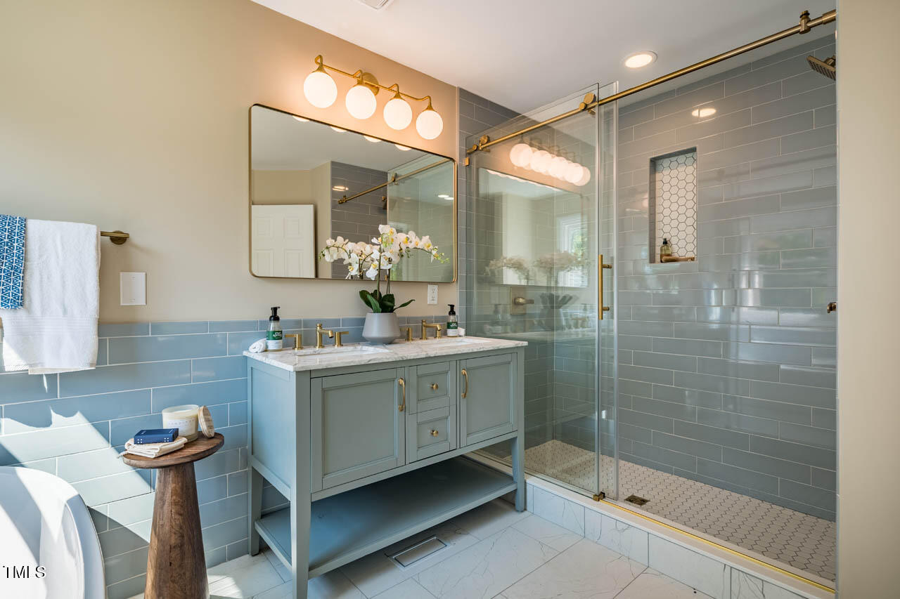 103 Windhover Drive Chapel Hill, NC 27514 - Photo 37 of 61 a bathroom with a sink mirror and a shower