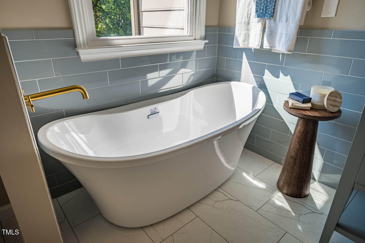 103 Windhover Drive Chapel Hill, NC 27514 - Photo 38 of 61 a white bath tub sitting in a bathroom